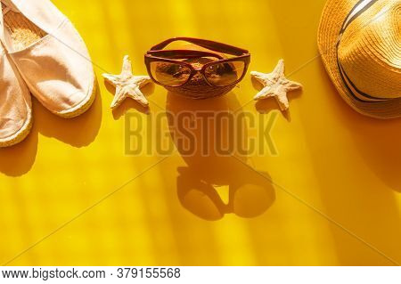 Flat Lay Of Summer And Beach Holiday. Sunglasses, White Espadrilles, Coconut In Yellow Background. C