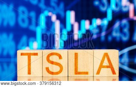 Tsla. Wooden Blocks With The Inscription Tsla On The Background Of The Stock Chart
