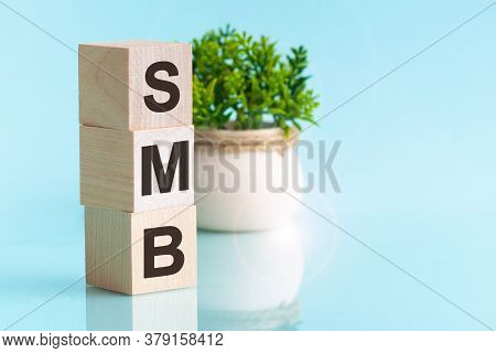 Hree Wooden Cubes - Letters Smb Meaning Small To Medium Sized Business On Them, Space For Text At Ri