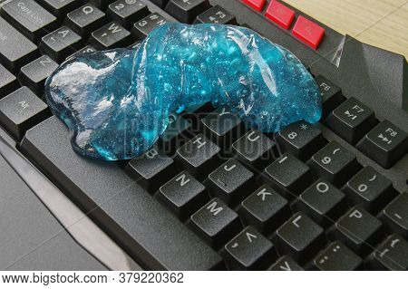 Blue Soft Gel Cleaning Dust On Keyboard. Concept Cleaning Your Computers Keyboard.