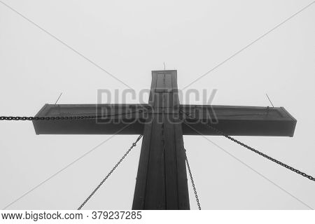 Wooden Cross Held By Chains On Top Of Hochlantsch Mountain In Fischbach Alps, Austria. A Huge Sign O