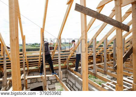 Fasteners And Installation Of Roof Rafters By Workers. Preparation For Laying Slate. Construction An