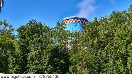 Cooling Tower Heat Station Out Behind Trees. Color