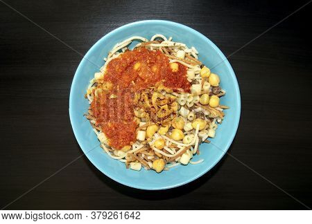 Famous Traditional Arabic, Egyptian Dish - Koshari. National Kushari In A Turquoise Plate On Dark Wo