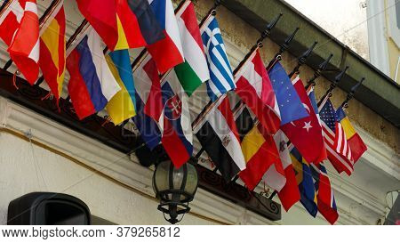 Many Flags Of Oecd Countries Hang On The Wall Of The Building.