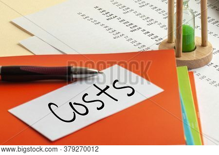 Paper With Costs On A Table, Concept