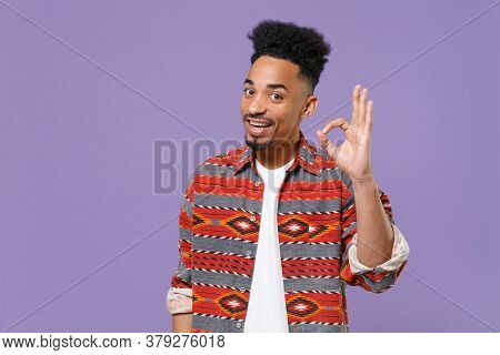 Smiling Young African American Guy In Casual Colorful Shirt Posing Isolated On Violet Background Stu