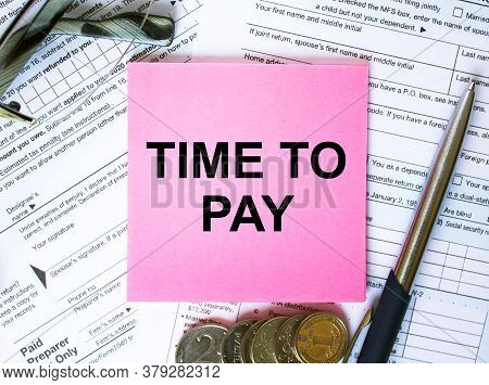 Text Time To Pay On Note Paper With The U.s Irs 1040 Form,pen And Glasses
