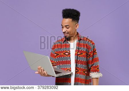 Smiling Young African American Guy In Casual Colorful Shirt Posing Isolated On Violet Background Stu