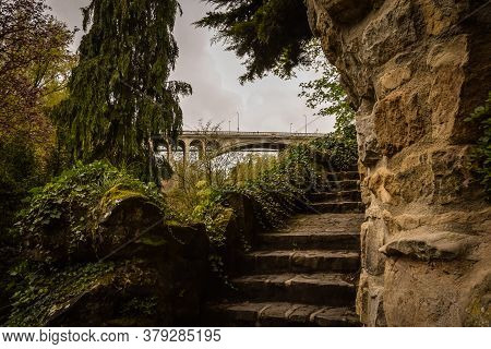 A Fabulous View Of The Stone Steps Covered With Green Plants, In The Background The Adolf Bridge. Lu