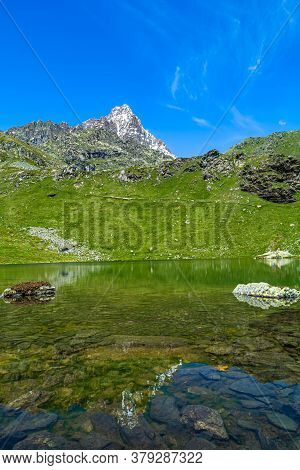 Hiking In The Monviso Valleys Between Streams, Waterfalls And Flowery Pastures