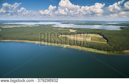 Lake Shore In Forest Background