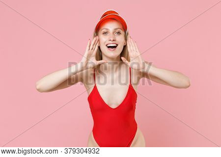 Cheerful Young Blonde Woman Girl In Red One-piece Swimsuit Cap Isolated On Pink Background. People S