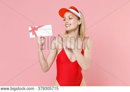 Smiling Young Blonde Woman In Red One-piece Swimsuit Cap Posing Isolated On Pink Background. People 