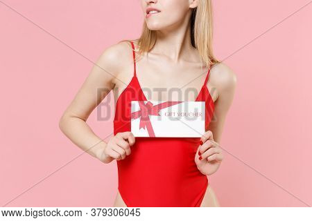 Cropped Image Of Young Blonde Woman Girl In Red One-piece Swimsuit Cap Isolated On Pink Background. 