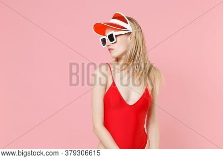 Beautiful Young Blonde Woman Girl In Red One-piece Swimsuit Cap Eyeglasses Isolated On Pastel Pink B