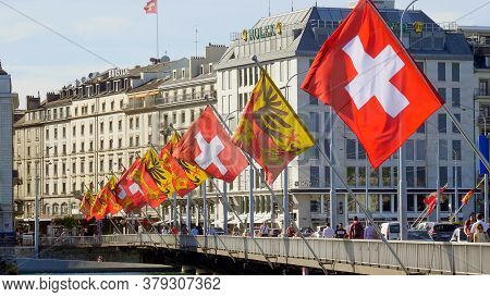 Flags Of Switzerland And The City Of Geneva On A Bridge In Geneva - City Of Geneva, Switzerland - Ju