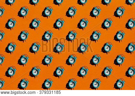 Blue Alarm Clock On Orange Background. Back To School Concept. Creative Design, Minimal Flat Lay Con