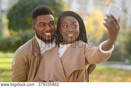 Beautiful Happy Afro Couple Taking Self-portrait, Capturing Their Happy Moments Together While Walki