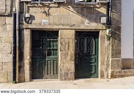 Santiago De Compostela, Spain - July 18, 2020: Old House With Green Wooden Doors In Medieval Town