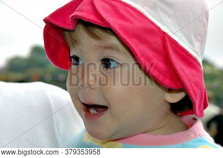 Close-up Of Beautiful Baby Asian Girl Smiling.