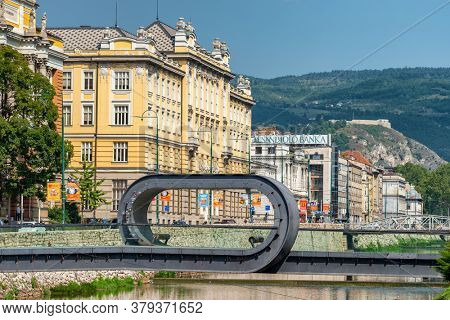 Sarajevo, Bosnia and Herzegovina - August 28, 2019: Festina lente is a pedestrian bridge over the river Miljacka in Sarajevo, BiH