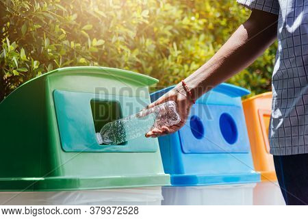 Selective Focus Close Up The Man Black Hand Throwing An Empty Plastic Water Bottle In The Recycling 