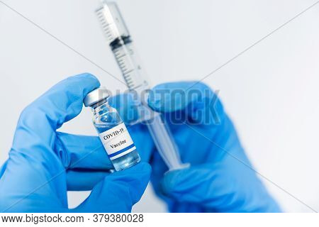 Doctor, Scientist, Researcher Hand In Blue Gloves Or Protective Suit Preparing For Human Clinical In