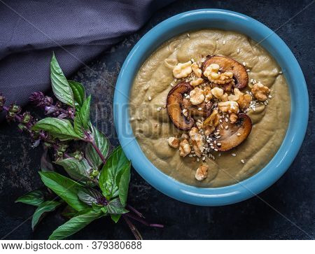 Eggplant Soup With Miso, Mushrooms And Sesami Seeds And A Bouquet Of Fresh Thai Basil.