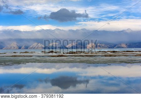 Baikal, Mountains And Ice On The Lake, Clouds Reflecting In The Water