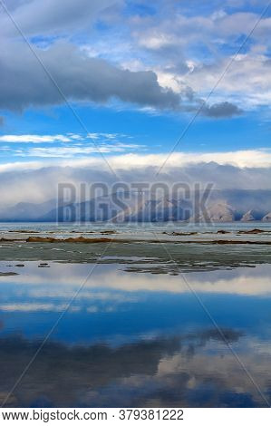 Baikal, Mountains And Ice On The Lake, Clouds Reflecting In The Water
