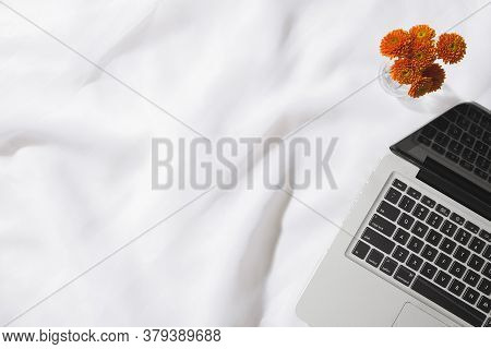 Top view of voile fabric background with flowers in two corners with space for text