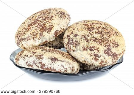 Four Gingerbread Cookies On A Plate Isolated On White Background
