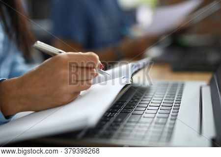 Female Hand Holds Pen With Notebook. Copywriting Courses For Beginners Concept