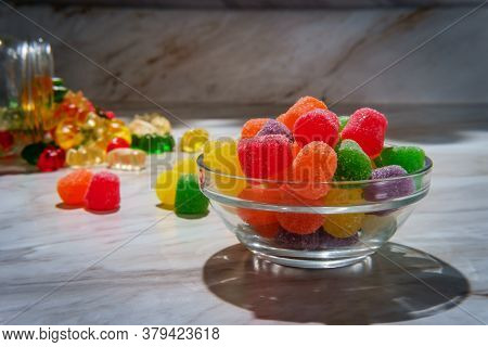 Granulated Sugar Coated Candy Gumdrops With Spilled Jar Of Gummy Bears In Background