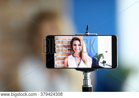 Close-up Of Woman Recording Video On Smartphone. Video-blogger Speaking On Camera Of Cellphone. Lady