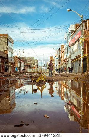 Desaguadero, Puno / Peru - April 4 2016: Young Man With A Skateboard In A Desolted Teared Apart Stre