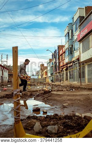 Desaguadero, Puno / Peru - April 4 2016: Young Man With A Skateboard In A Desolted Teared Apart Stre