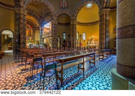 ALBA, ITALY - JUNE 23, 2020: Interior view of the nave, wooden pews and altar in Madonna della Moretta church in Alba - small town in Piedmont, famous for truffles and wine production.