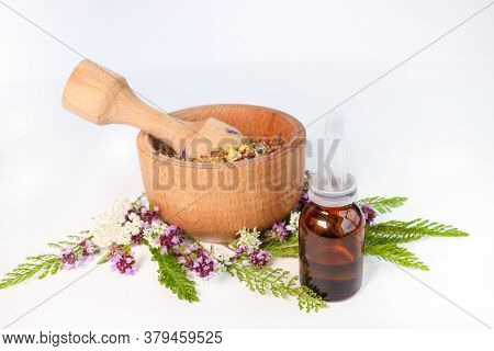 Natural Oils In A Glass Bottle On A White Background. The Concept Of Pure Organic Ingredients In Cos