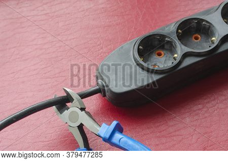 Nippers With Blue Handles Cut The Cable Splitter Cable. Emergency Disconnection Of The Consumer From