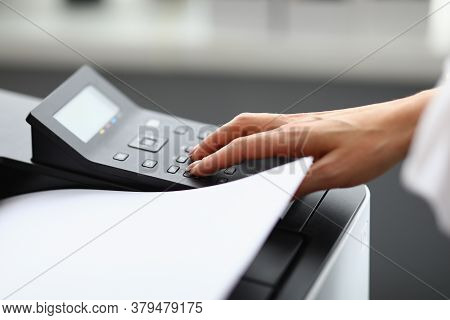 A Woman Uses Office Equipment To Print. Hand Presses Buttons On Printer. Cost-effective And Easy Dev