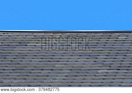 Roof Made Of Black Slate On A Background Of Blue Sky, New Roof
