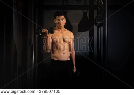 Handsome Man Raising Dumbbell Up With Right Hand,doing Exercise For Buit Muscle,,fit And Firm Body
