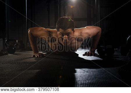 Handsome Man Doing Exercise For Buit Muscle,fit And Firm Body