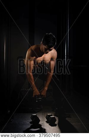 Handsome Man Raising Dumbbell,doing Exercise For Buit Muscle,fit And Firm Body,model Posing