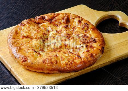 Georgian Khachapuri Mergoli On A Cutting Board. National Cheese Tortilla. Toasted Delicious Crust. T