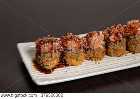 Sushi Hoso Fuji Plate With Spicy Salmon, Philadelphia And Unagi Sauce On Wooden Background