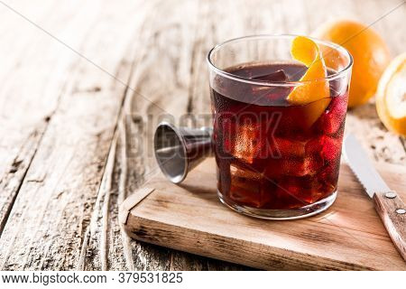 Boulevardier Cocktail And Orange Zest On Wooden Table. Copy Space