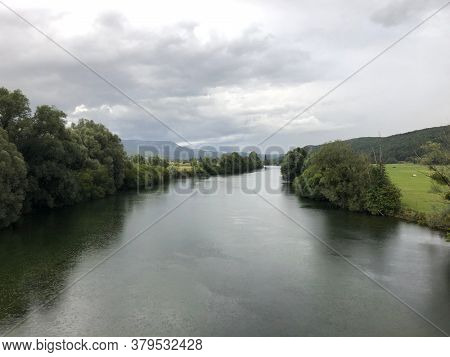 French river La Loue in Jura countryside. Cloudy landscape.